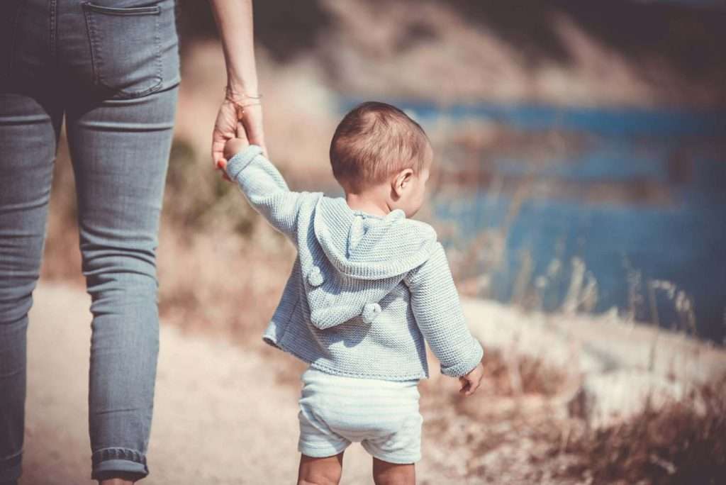 Adult holding child outdoors